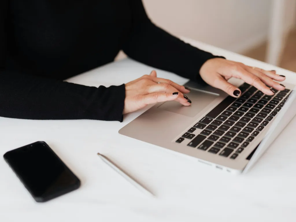 woman typing at a laptop